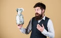 Banking concept. General savings tips. Man bearded hipster hold jar full of cash. Financial success. Businessman with Royalty Free Stock Photo