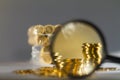 Banking and finance concept, coins with a microscope looking at it Royalty Free Stock Photo