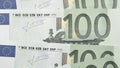 Banknote of 100 euro closeup. Pale wallpaper about economy or finance of European Union. Partially discolored news background