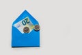 Banknote of 20 euros in blue envelope on a light background and two coins of one euro. Royalty Free Stock Photo