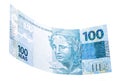Banknote of one hundred reais from brazil falling on isolated white background Royalty Free Stock Photo