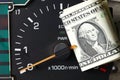 Banknote put tachometer gauge. Royalty Free Stock Photo