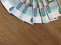 Russian banknotes in denominations of 1000 rubles on a wooden background