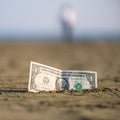 Banknote of value of one dollar in the the sand on the beach. Concept of cheap travel and vacation. Royalty Free Stock Photo