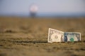 Banknote of value of one dollar in the the sand on the beach. Concept of cheap travel and vacation. Royalty Free Stock Photo