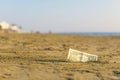 Banknote of value of one dollar in the the sand on the beach. Concept of cheap travel and vacation. Royalty Free Stock Photo