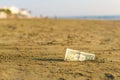 Banknote of value of one dollar in the the sand on the beach. Concept of cheap travel and vacation. Royalty Free Stock Photo