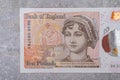 Banknotes in denominations of 10 with the image of a portrait of Jane Austen on a gray background Royalty Free Stock Photo