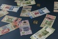 Banknotes of different denominations of Mexican currency, scattered on a blue superfice