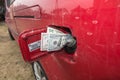 Banknotes, dollars in the fuel filler of a red car Royalty Free Stock Photo