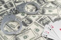 Banknotes of dollars, handcuffs, four ace of playing cards. Royalty Free Stock Photo