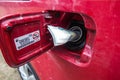 Banknotes, euro in the fuel filler of a red car Royalty Free Stock Photo