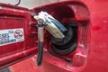 Banknotes, euro in the fuel filler of a red car Royalty Free Stock Photo