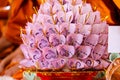 Banknotes are finely folded to decorate on the golen plate to give to the Buddhist temple Royalty Free Stock Photo