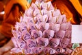 Banknotes are finely folded to decorate on the golen plate to give to the Buddhist temple Royalty Free Stock Photo