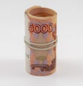 Banknotes five thousand rubles 5000 in a roll with an elastic band. Russian currency to save. Close-up, white background. The conc Royalty Free Stock Photo