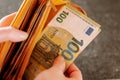 Banknotes in hand.The hand takes out one hundred euro bill from the wallet. Royalty Free Stock Photo