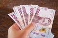 Banknotes of 1000 hryvnia in a woman`s hand. Close-up.