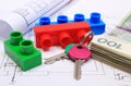 Banknotes, keys, building blocks and electrical diagrams on drawing of house Royalty Free Stock Photo