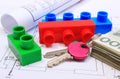 Banknotes, keys, building blocks and electrical diagrams on drawing of house Royalty Free Stock Photo