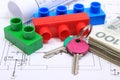 Banknotes, keys, building blocks and electrical diagrams on drawing of house Royalty Free Stock Photo