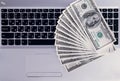 Banknotes over laptop keyboard dollars money Royalty Free Stock Photo