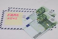 Banknotes on a postal envelope on a light background. Fake news sticker on the envelope. Corrupt journalism. Fake news