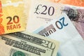 Banknotes, pound sterling, dollar, real and euro, closeup