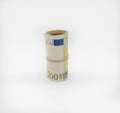 Banknotes two hundred 200 euros in a roll with an elastic band. European currency to save. Close-up, white background. Royalty Free Stock Photo