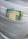 Banknotes of two thousand and one thousand Russian rubles stick out from the back pocket of jeans. The concept of poverty and Royalty Free Stock Photo