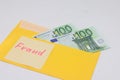 Banknotes in a yellow envelope. Fraud concept. Financial fraud. Close-up. Sticker labeled scam.