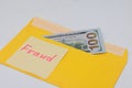 Banknotes in a yellow envelope. Fraud concept. Financial fraud. Close-up. Sticker labeled scam.