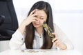 A bankrupt, broke and frustrated woman is having financial problems with coins left on the table and an empty wallet.