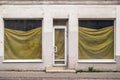 A bankrupt store with film-covered windows. Empty store front economic crisis. closed shop Royalty Free Stock Photo