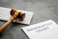 Bankruptcy court concept with gavel, document, keyboard on wooden background Royalty Free Stock Photo