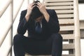 Bankruptcy layoff Asian businessman stress headache sitting on stairs step. Failed sad unemployed pain anxiety asia people man Royalty Free Stock Photo