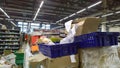 Bankruptcy and liquidation of supermarket. Retail industry. Huge pile of cardboard boxes with food on dirty floor in store. Messy.