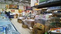 Bankruptcy of supermarket. Clutter, trash and scattered goods on dirty floor in the store. Mess, huge piles of cardboard boxes.