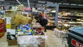 Bankruptcy of supermarket, largest retailer. Clutter, trash and scattered goods on dirty floor in a store. Mess, huge piles of Royalty Free Stock Photo