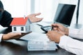 Banks approve loans to buy homes. Real estate agents explain the document for customers who come to contact to buy a house, buy or Royalty Free Stock Photo