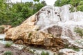 The banks of the mineral water stream White Ditch in Bagni San Filippo, covered with White Whale rock la Balena Bianca