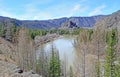 A mountain river flows along the foot of rocks and mountains Royalty Free Stock Photo