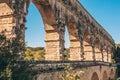 Banks of the river Gardon on the arched stone bridge of Pont du Gard - perspective