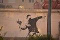Banksy Flower thrower on side of a garage in Bethlehem