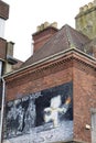 Banksy graffiti called 'Mild Mild West' on facade in Stokes Croft neighborhood in Bristol city