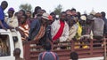 Banna man at back of a truck leaving market in the evening. Key