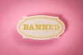 BANNED. Note sticker with text on pink background