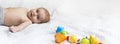 Banner adorable baby is lying on the bed in the bedroom on a white blanket The little boy has been resting for nine months. White Royalty Free Stock Photo