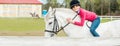 A sweet girl riding a white horse, an athlete engaged in equestrian sports, a girl hugs and kisses a horse. Royalty Free Stock Photo