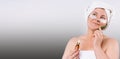 Banner. Blonde senior woman with disposable eye patches,lifting serum and aloe vera leaf looks to the side. Gray